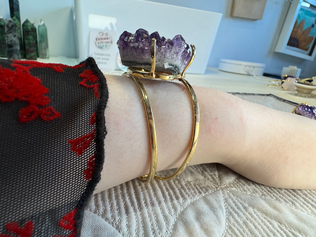 Gold bracelet on a wrist with a blurred background