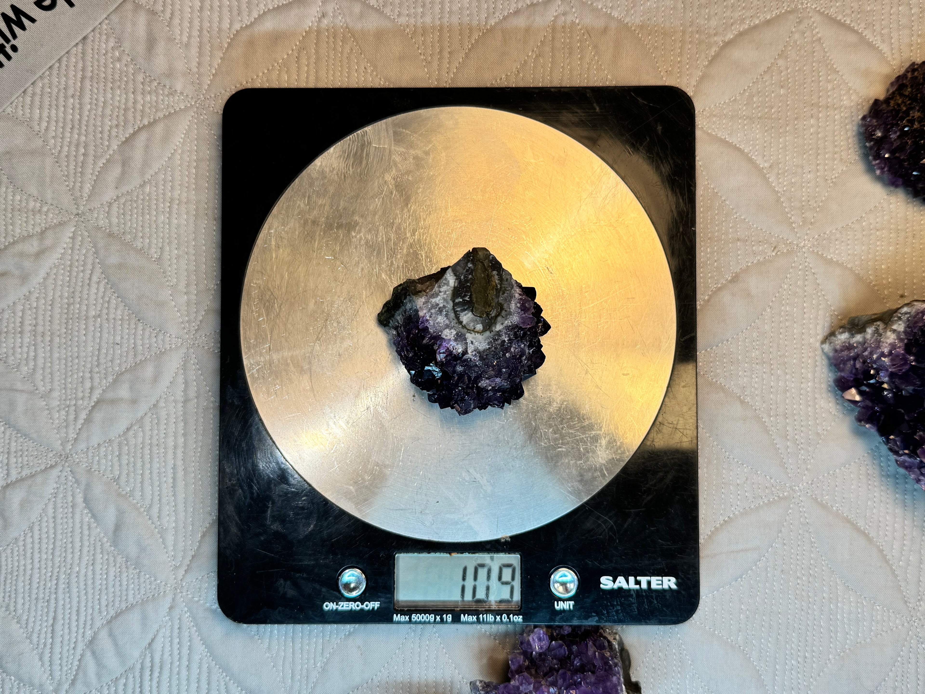 Mineral on a Salter scale with a textured surface background