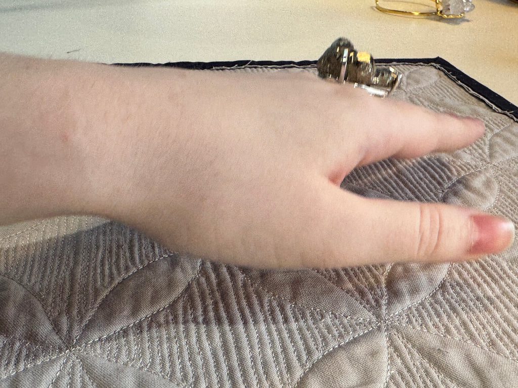 Hand on a textured fabric surface with a blurred background