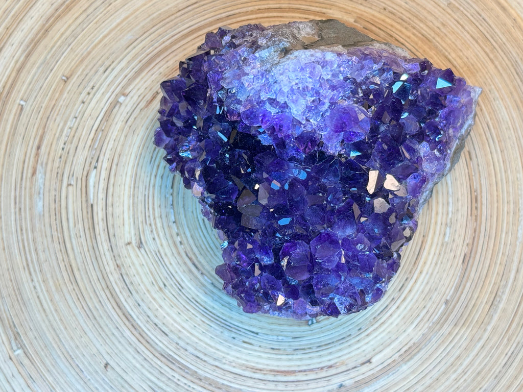 Purple crystal cluster on a woven surface