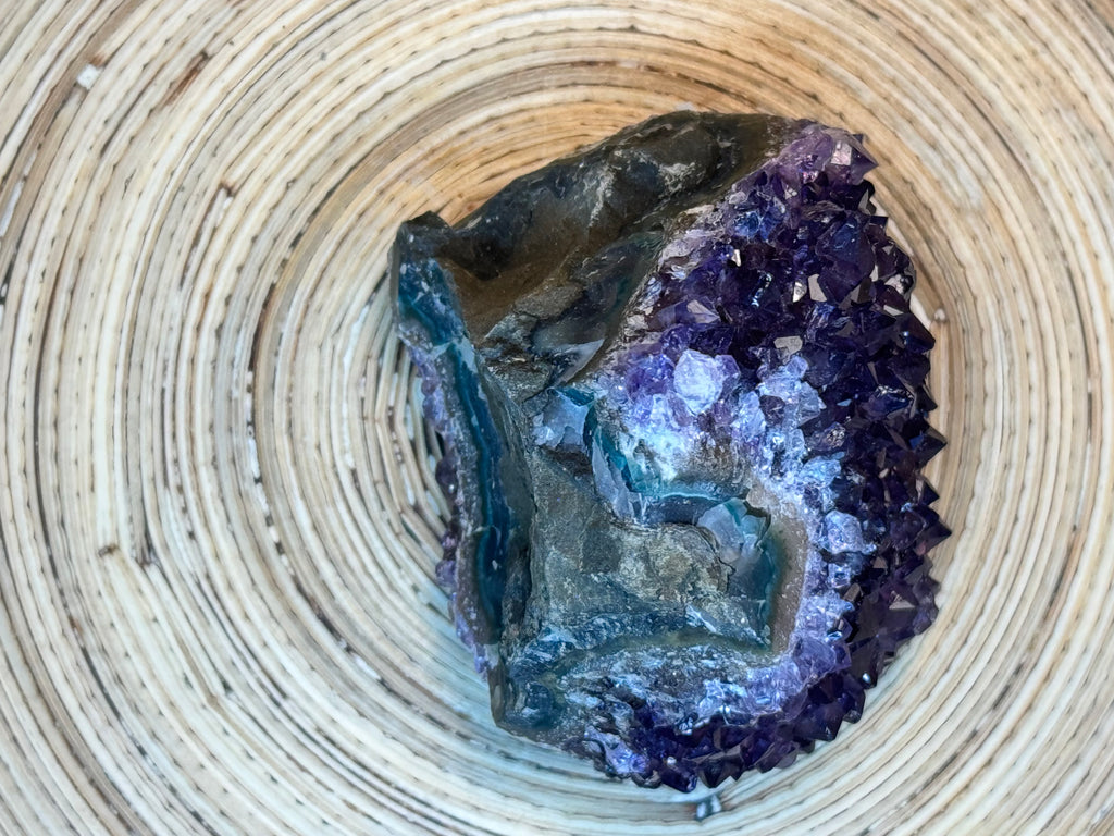 Amethyst crystal formation on a woven surface