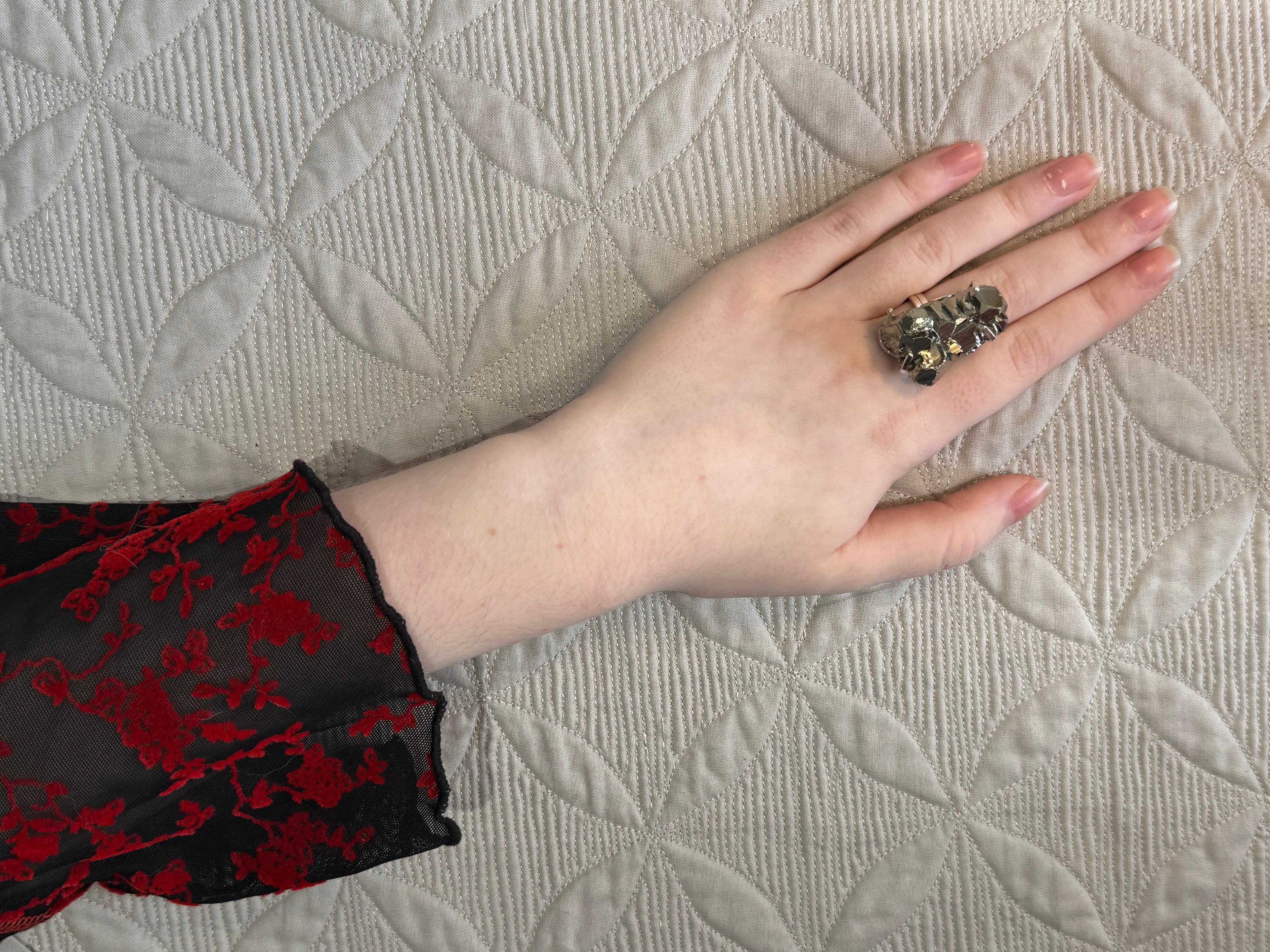Hand holding a small pile of coins on a textured surface