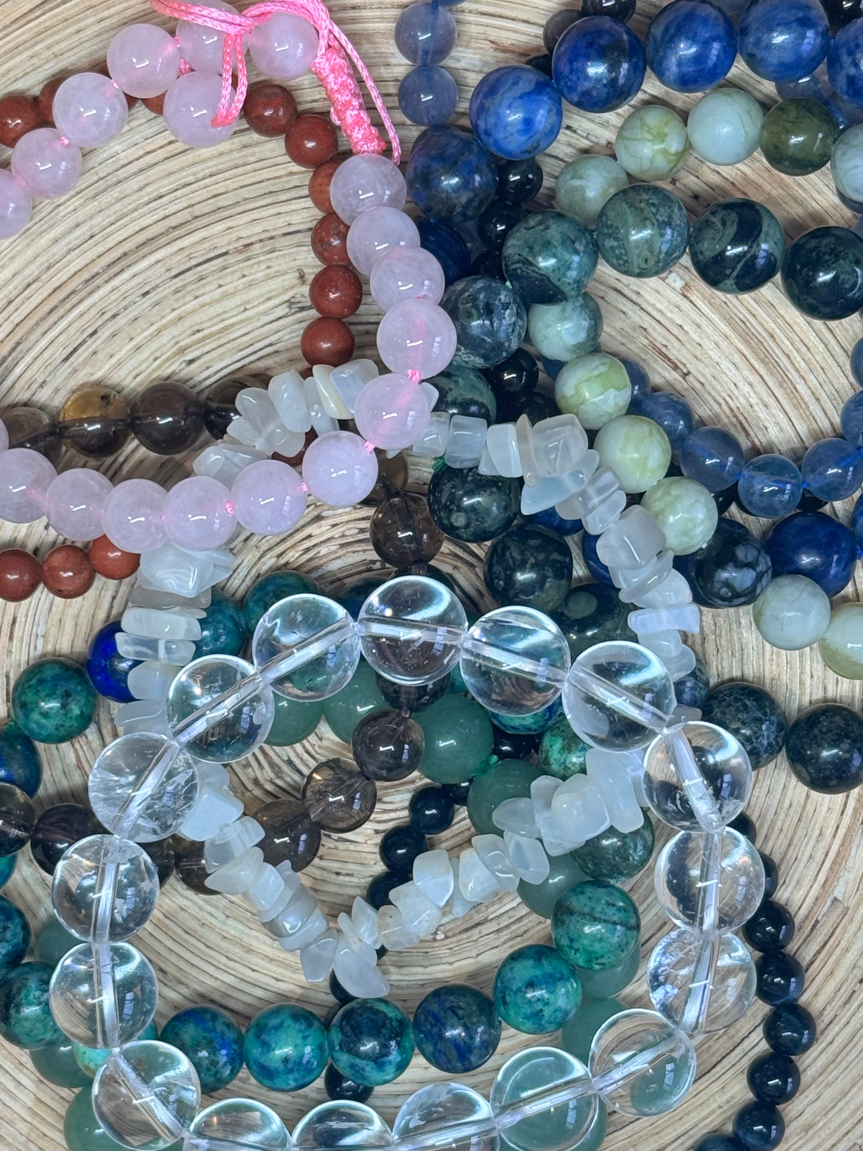 Collection of multicolored beaded bracelets on a woven surface