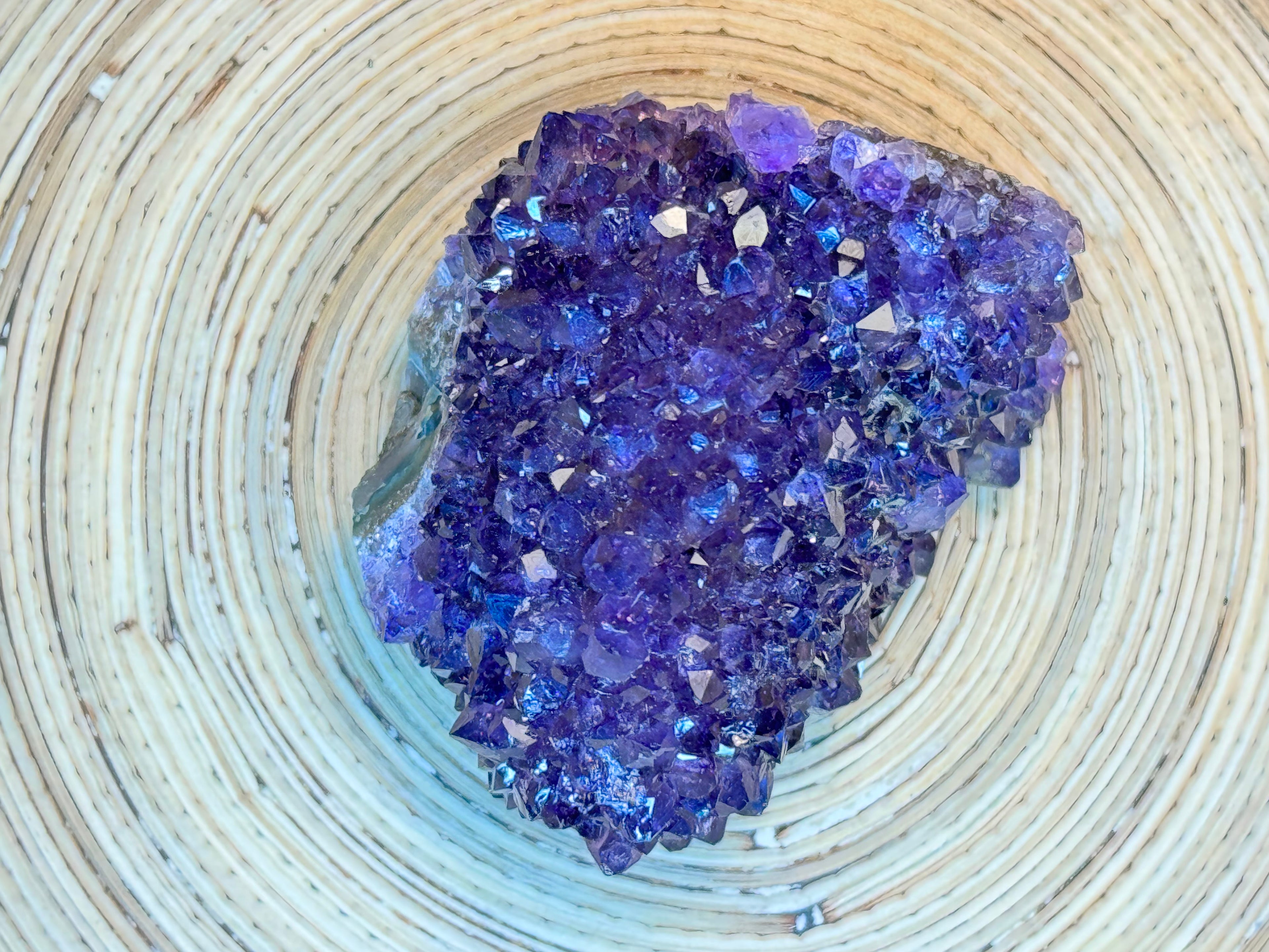 Purple crystal cluster on a wooden surface