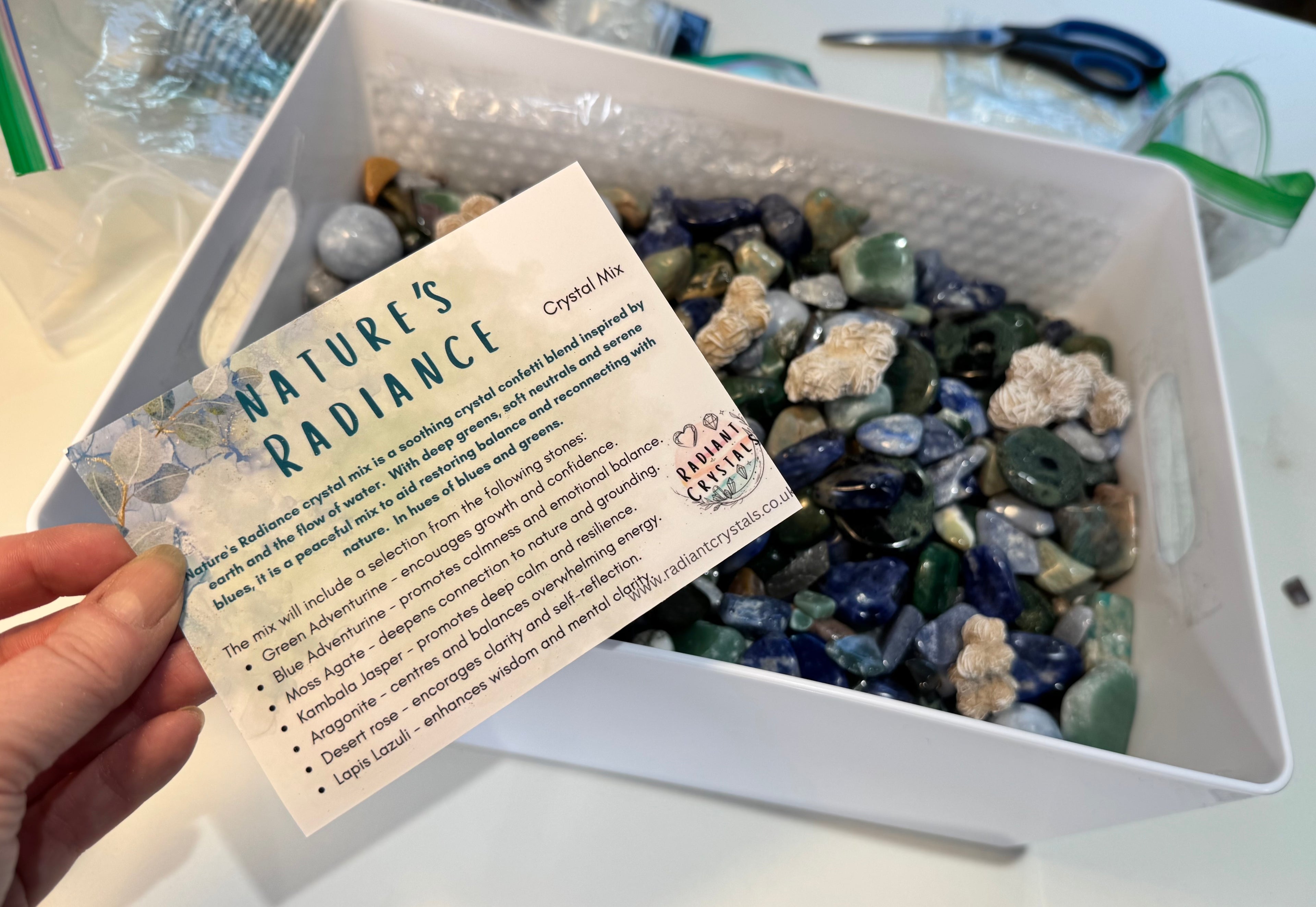 Box of assorted crystals with a 'Nature's Radiance' card on a white surface.