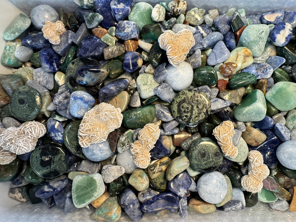Assorted colored stones with decorative elements on a white background