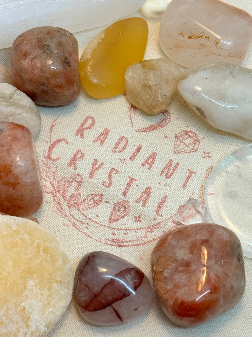 crystal tumble stones on a cotton bag with Radiant Crystals logo