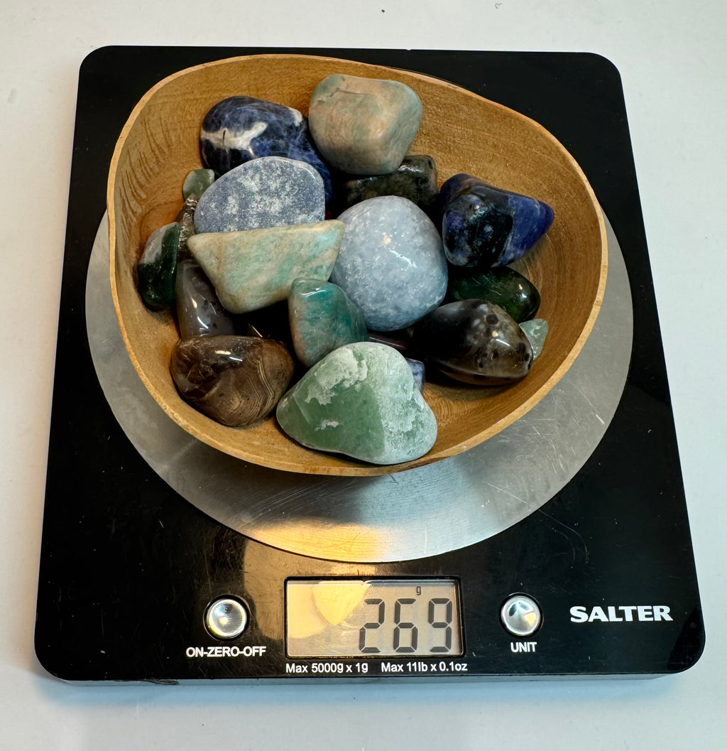 Bowl of multicolored stones on a Salter digital scale displaying a weight.