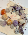 Assorted crystals on a white surface with 'Radiant Crystal' logo.