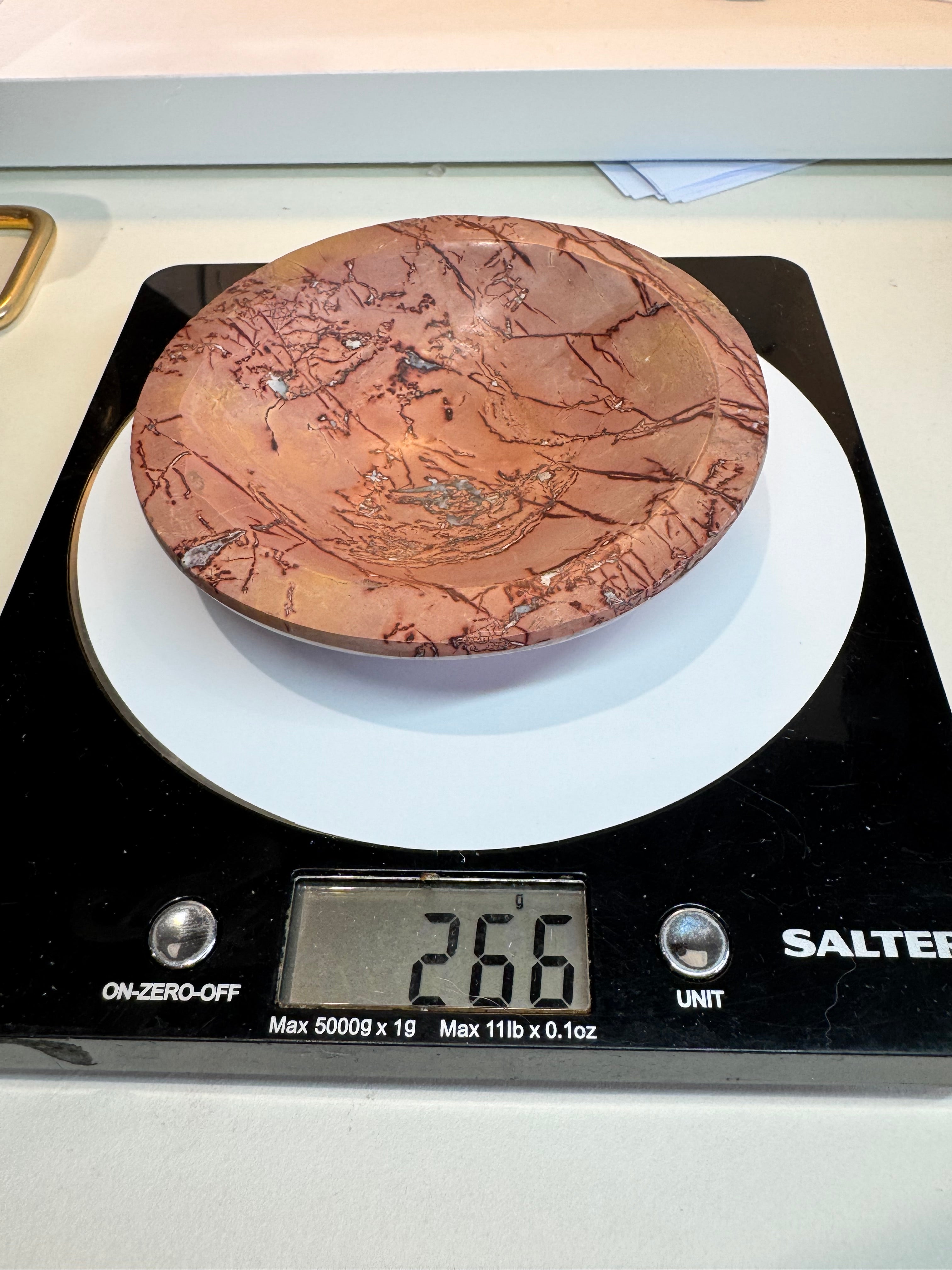 Copper object on a digital scale with a visible weight reading