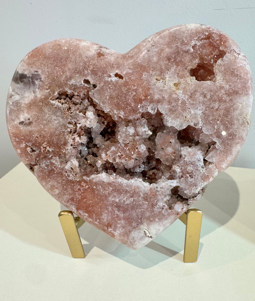 Heart-shaped crystal on a stand with a light background
