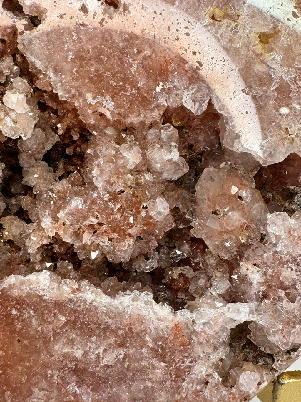 Close-up of crystalline rock formation with pink and brown hues