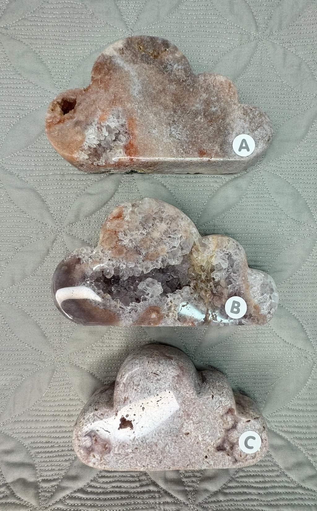 Three crystal rock specimens labeled A, B, and C on a textured surface.