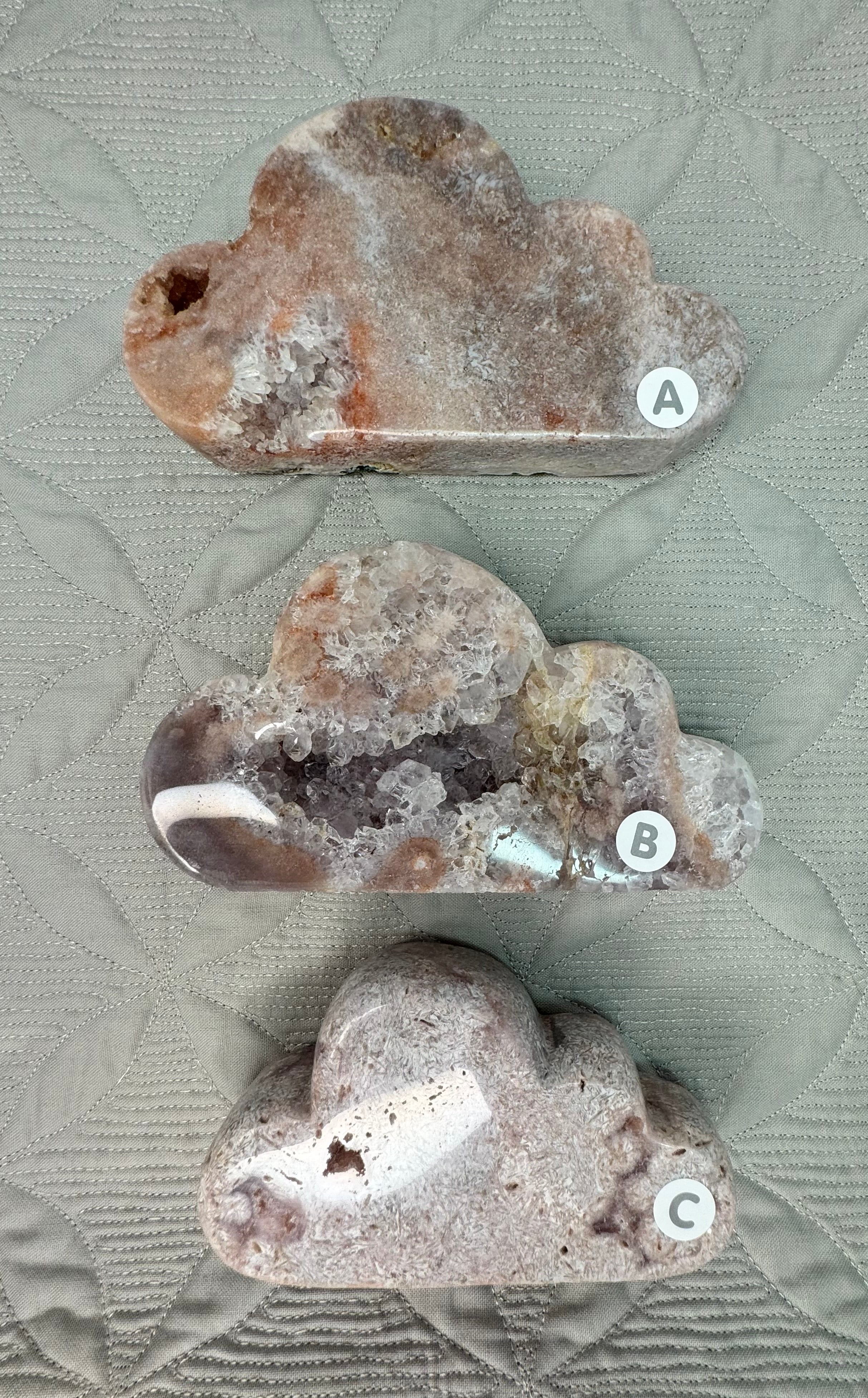 Three crystal rock specimens labeled A, B, and C on a textured surface.