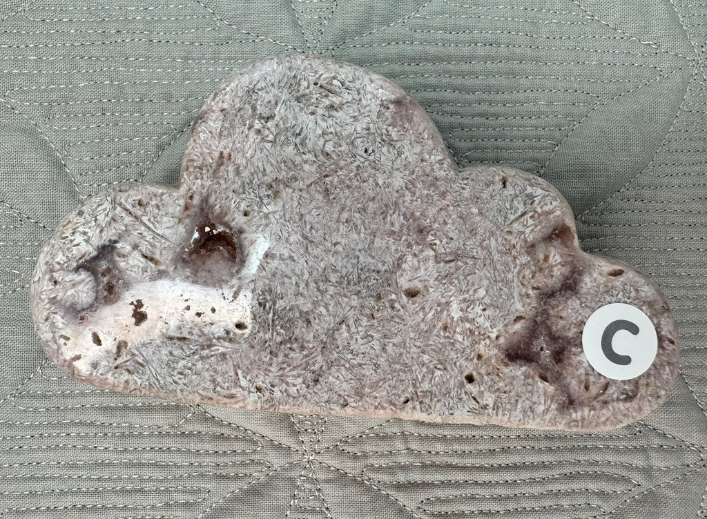 Close-up of a textured stone object on a patterned fabric background