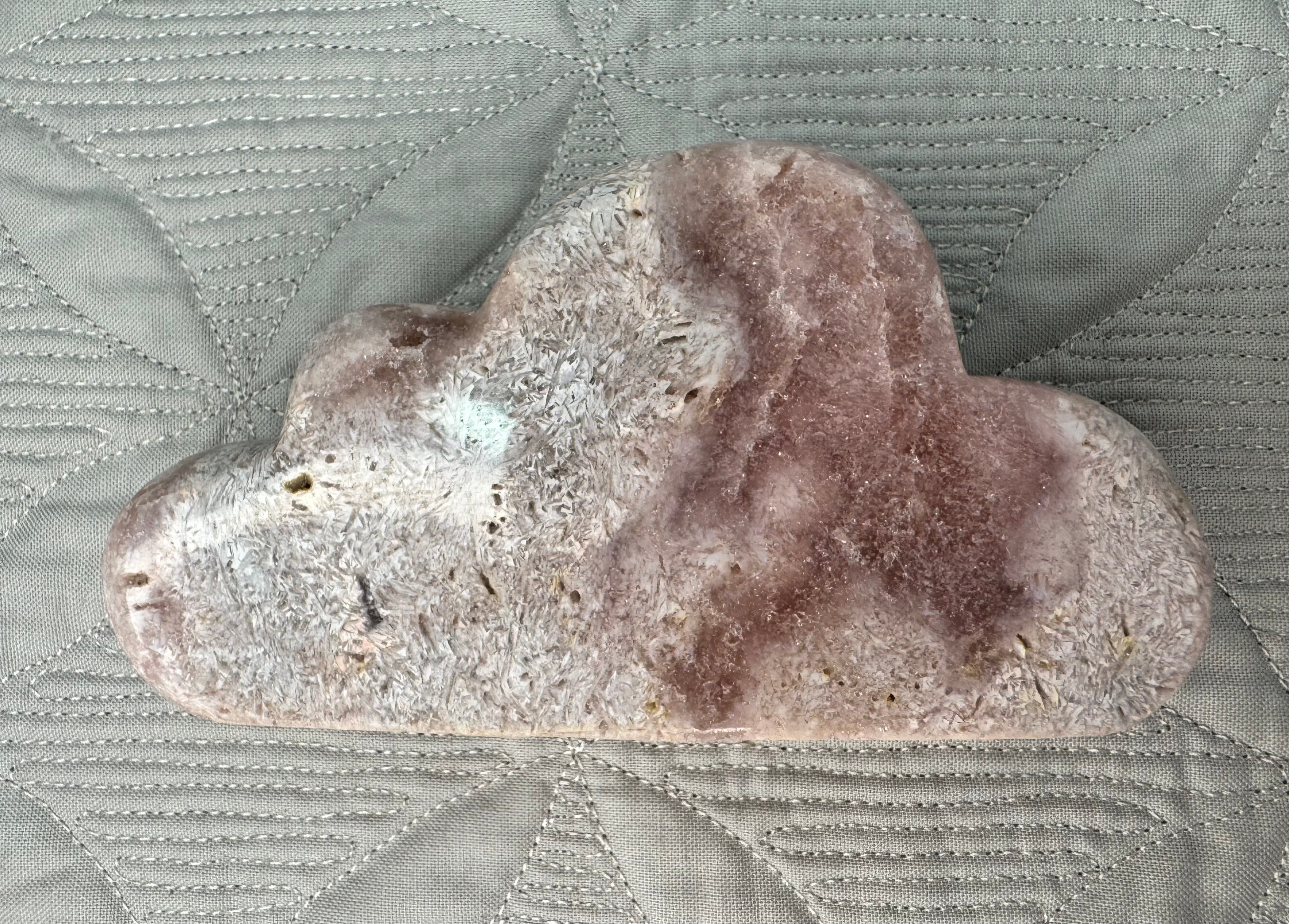 Heart-shaped stone on a textured fabric surface