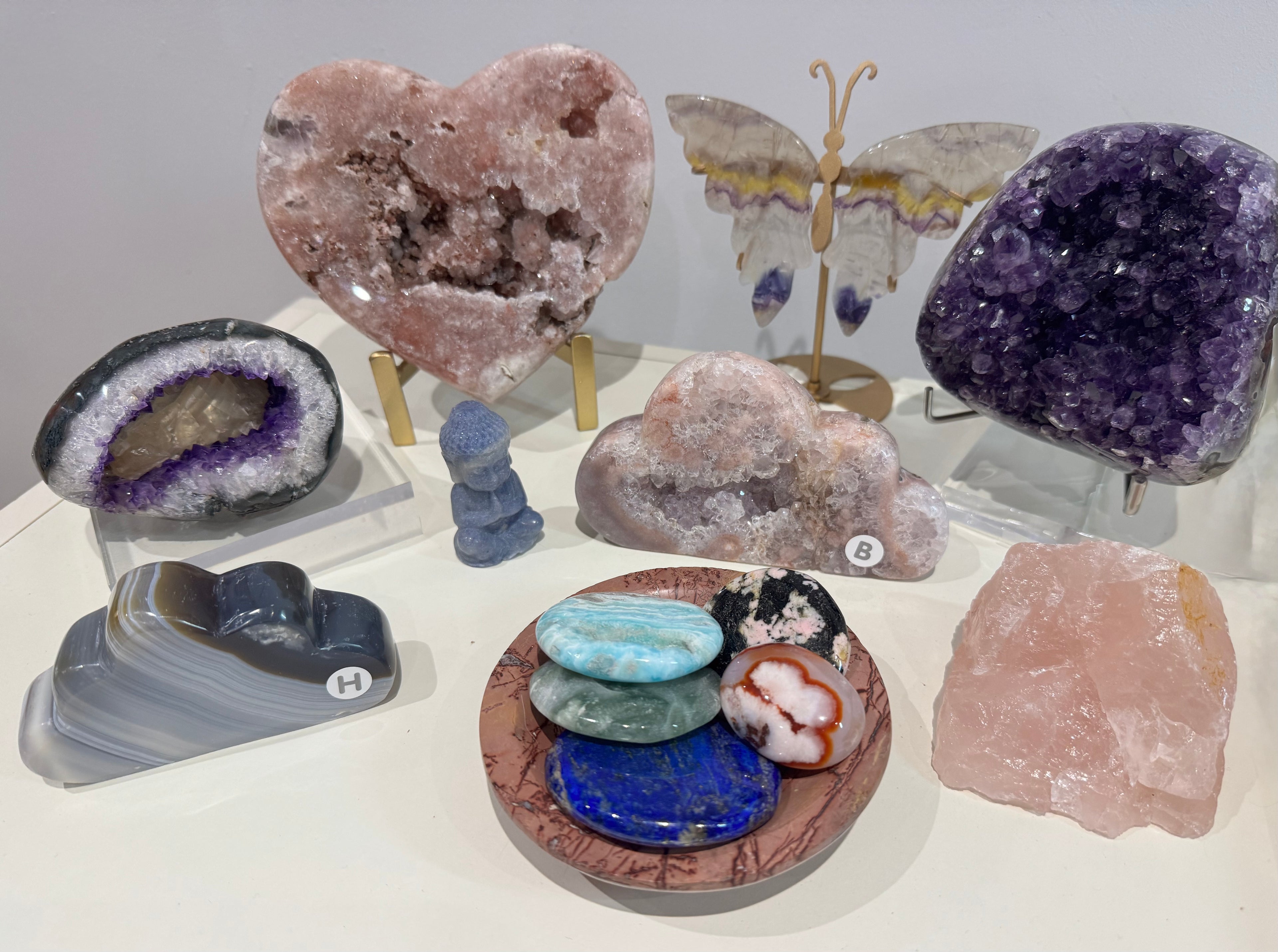 Collection of various crystals and rocks on a white surface