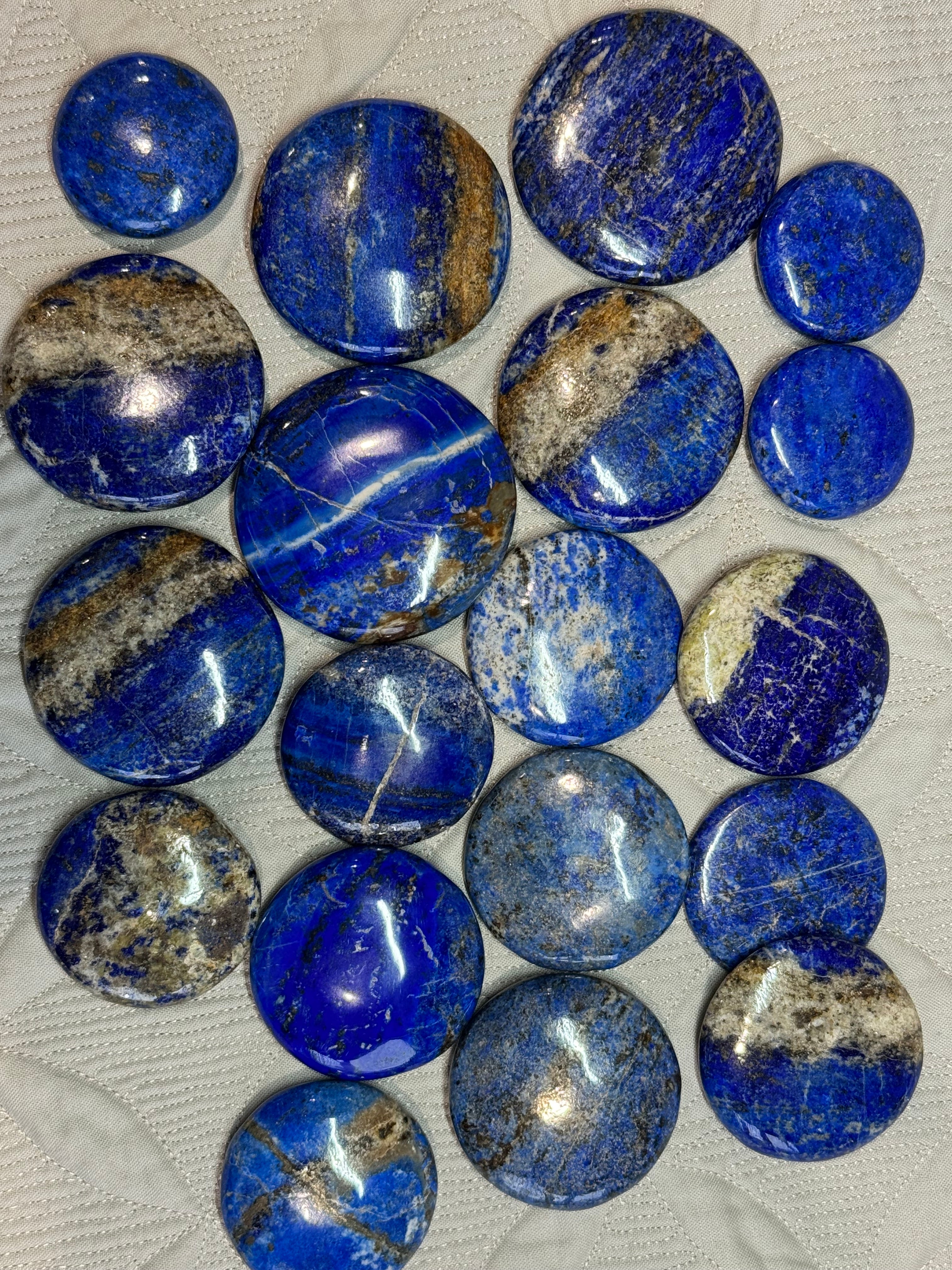 Collection of blue and gray stones on a textured surface
