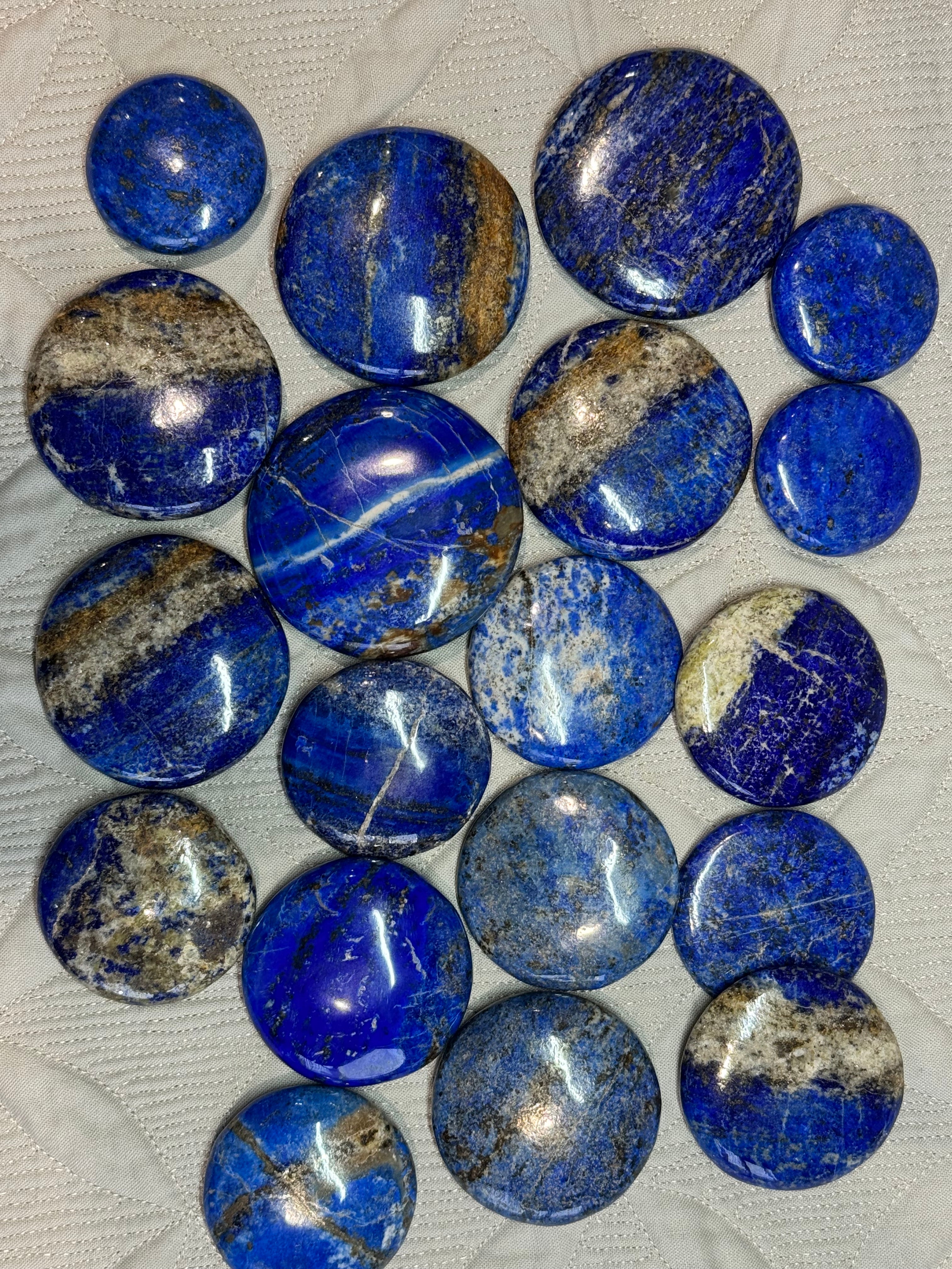 Collection of blue and gray stones on a textured white surface
