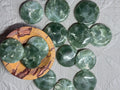 Green marbled stones on a textured surface