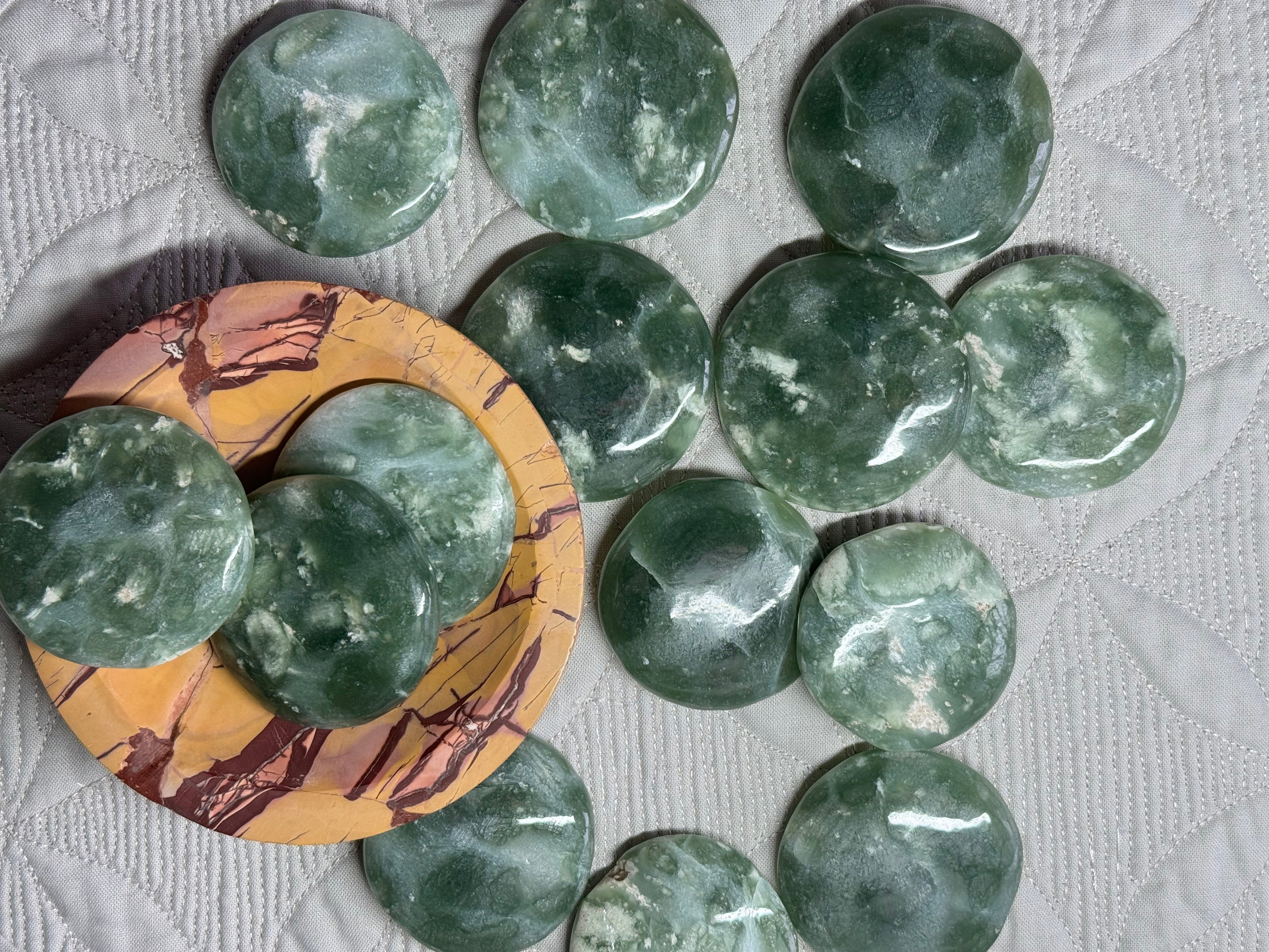 Green marbled stones on a textured surface