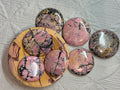 Set of pink marbled stones on a textured surface