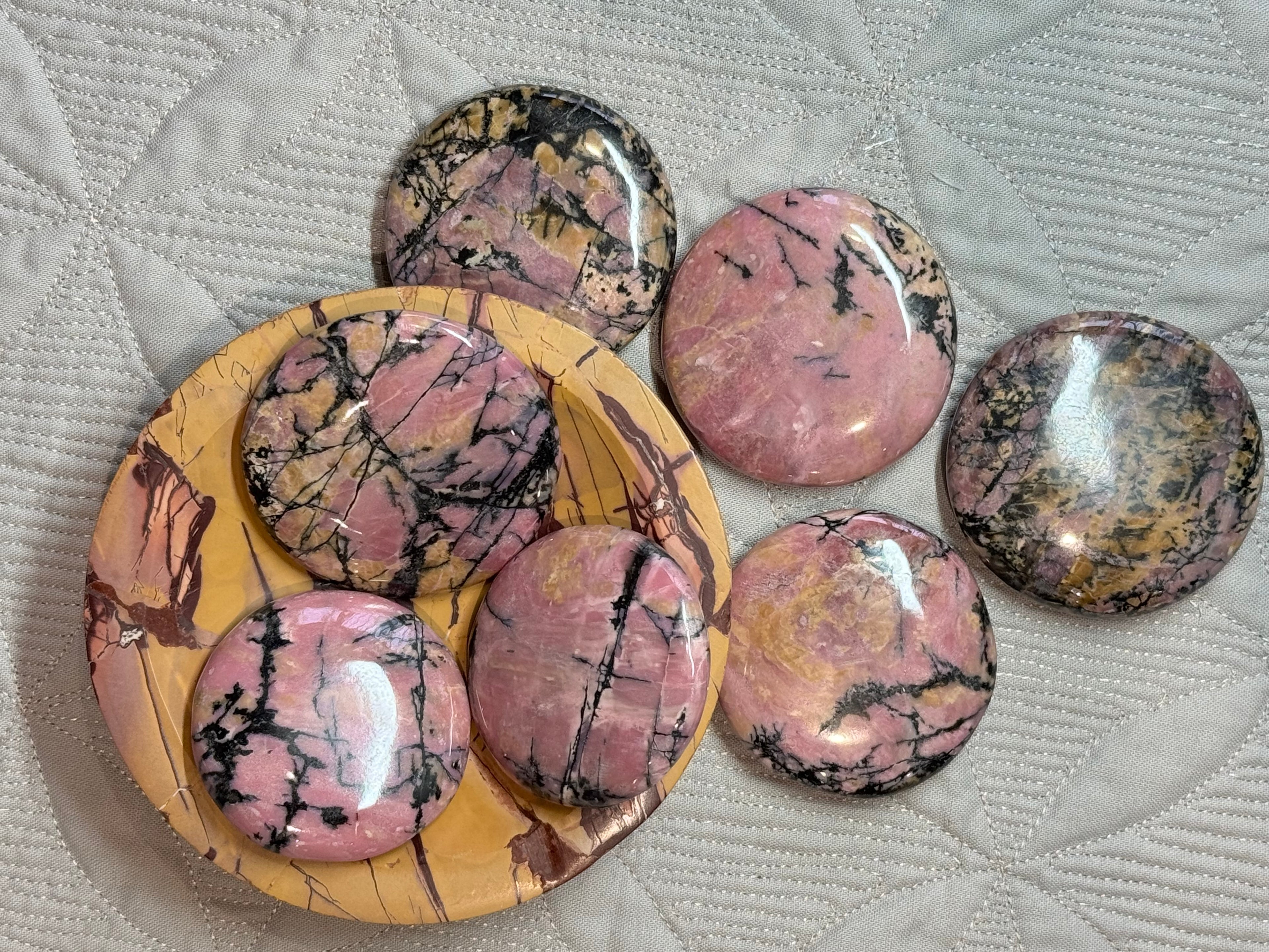 Set of pink marbled stones on a textured surface