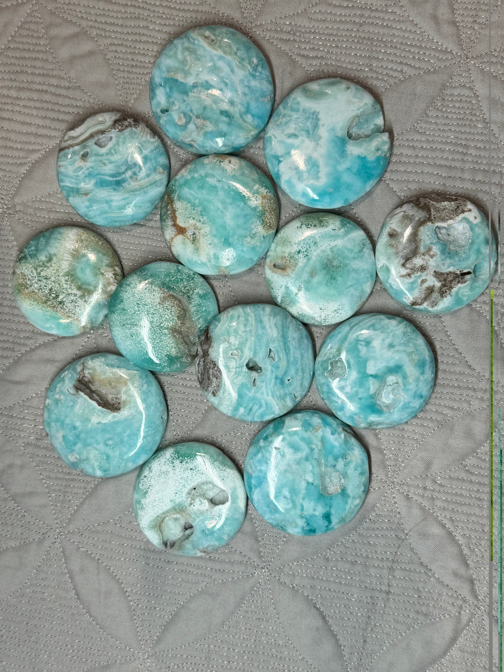 collection of blue stones on a grey textured background