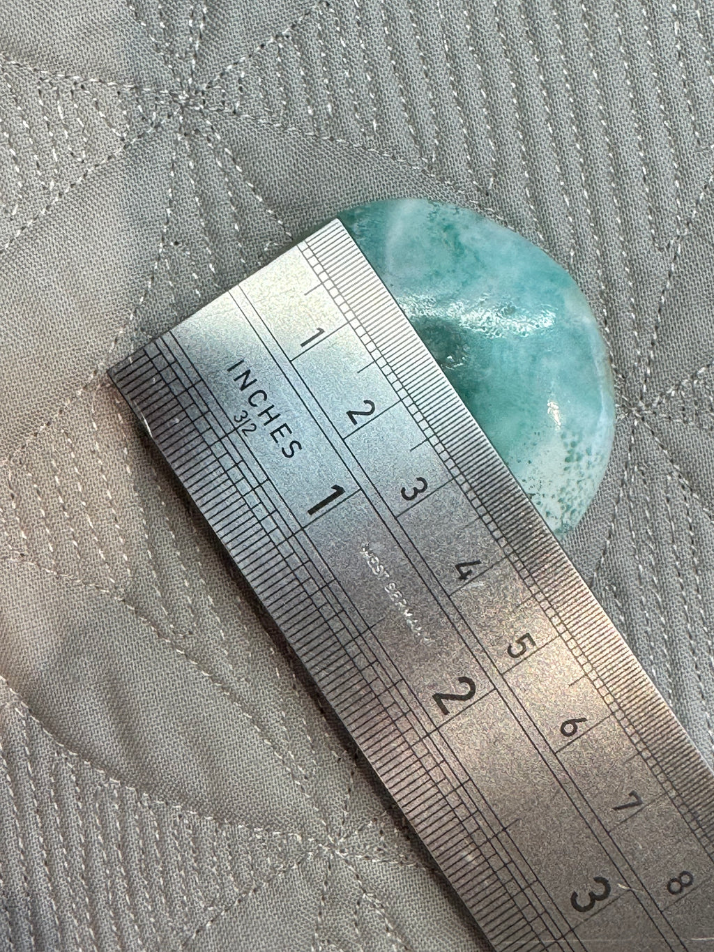 blue round stone with a ruler