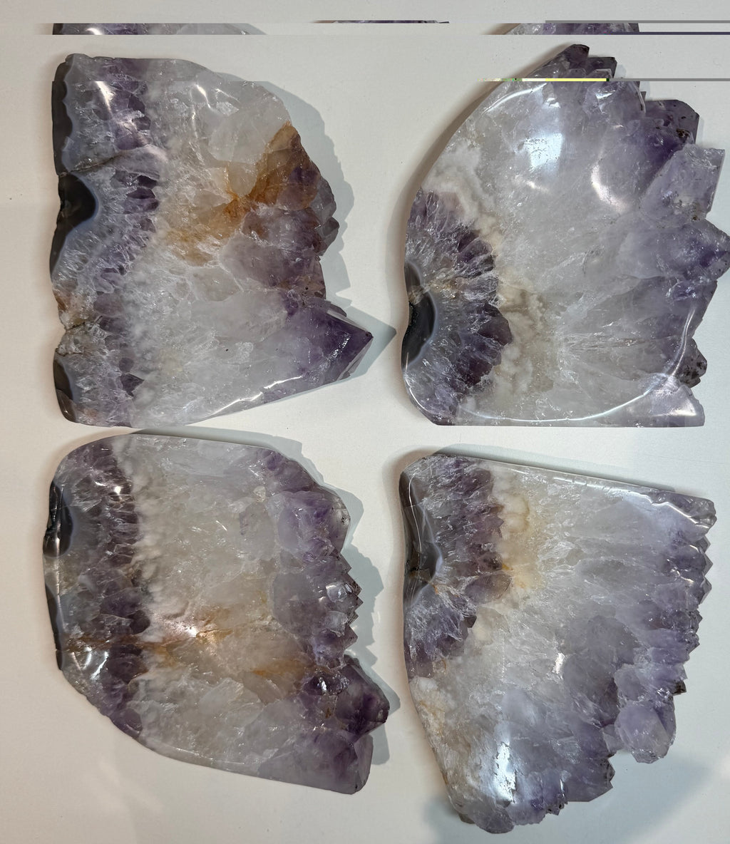 Four pieces of amethyst crystal on a white background