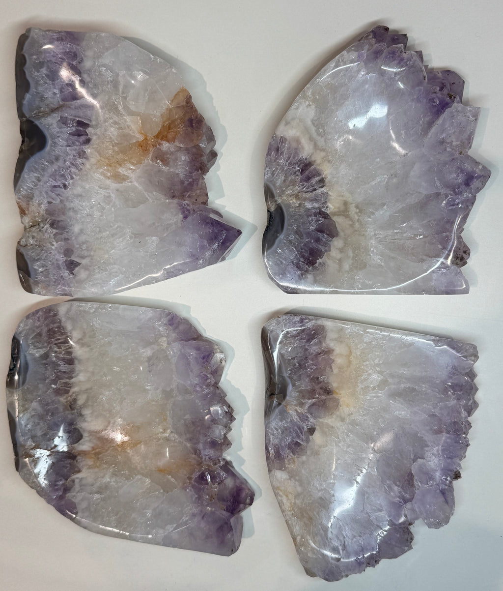 Four pieces of amethyst crystal on a white background