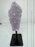 Lavander crystal on a black stand on a white background