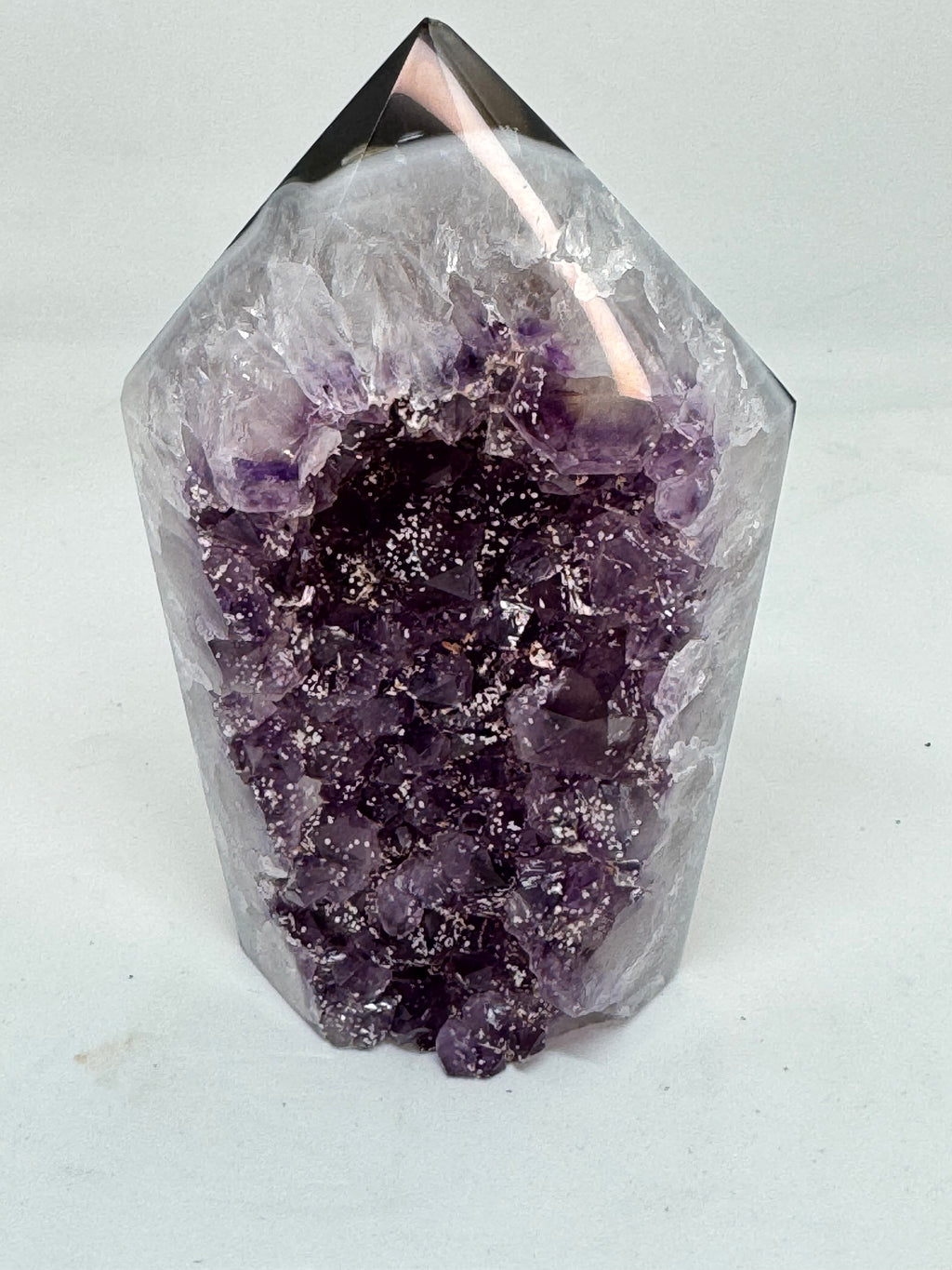 Amethyst crystal on a light gray background