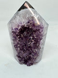 Amethyst crystal on a light gray background