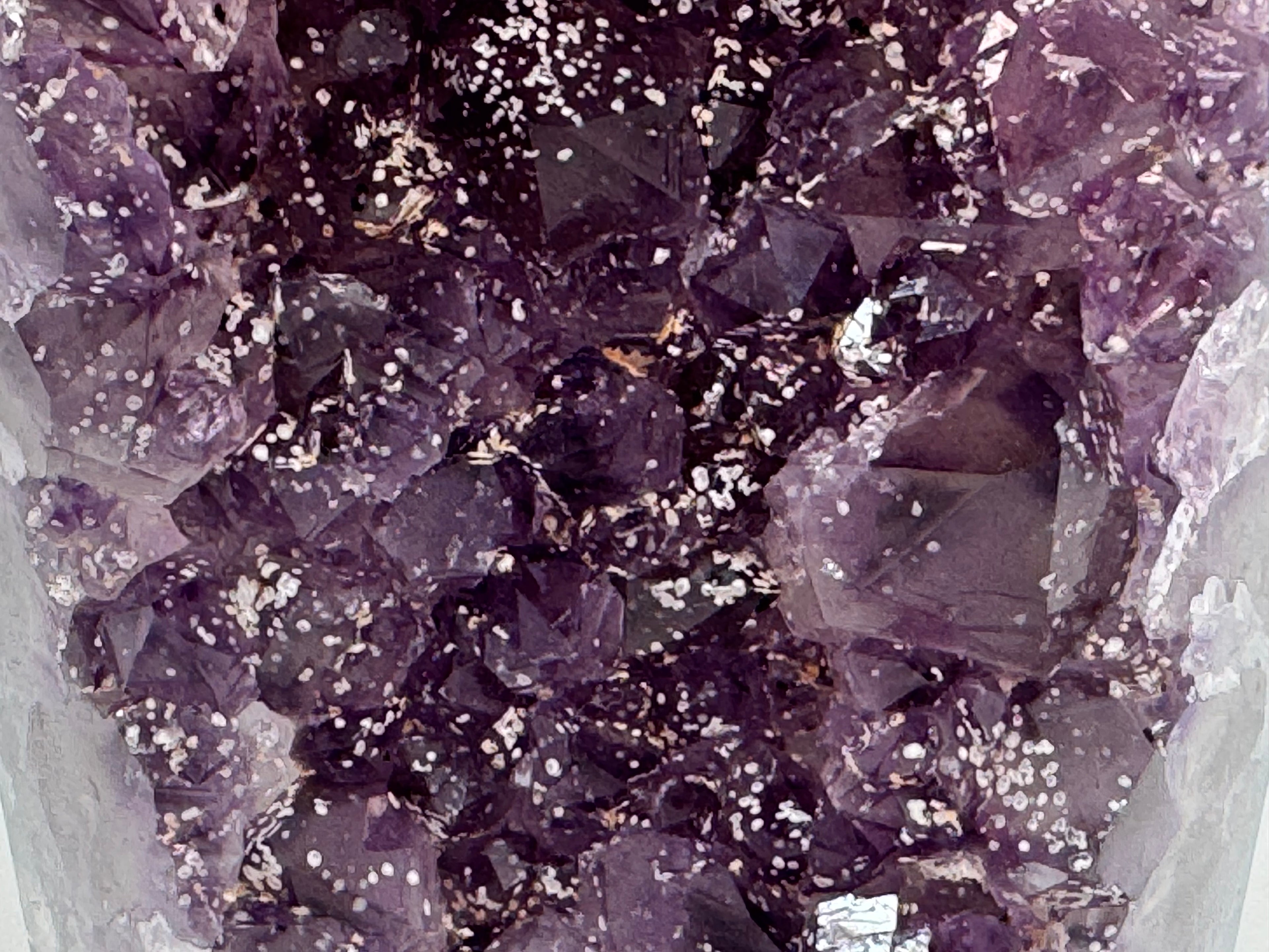 Close-up of purple crystals with a white background