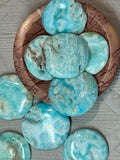 round Turquoise stones on a textured  bowl