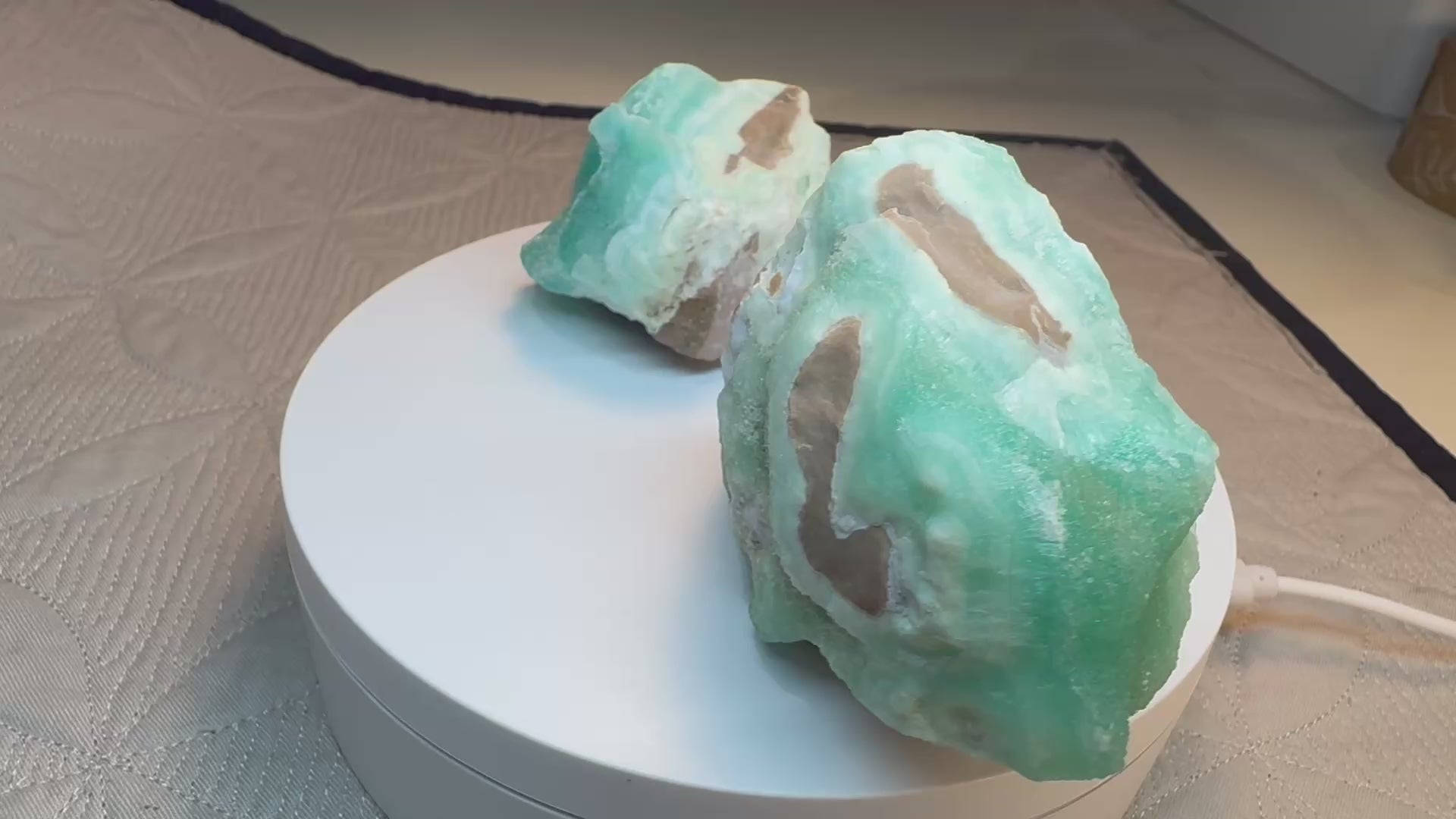 video of 2 green/blue crystals on a turntable