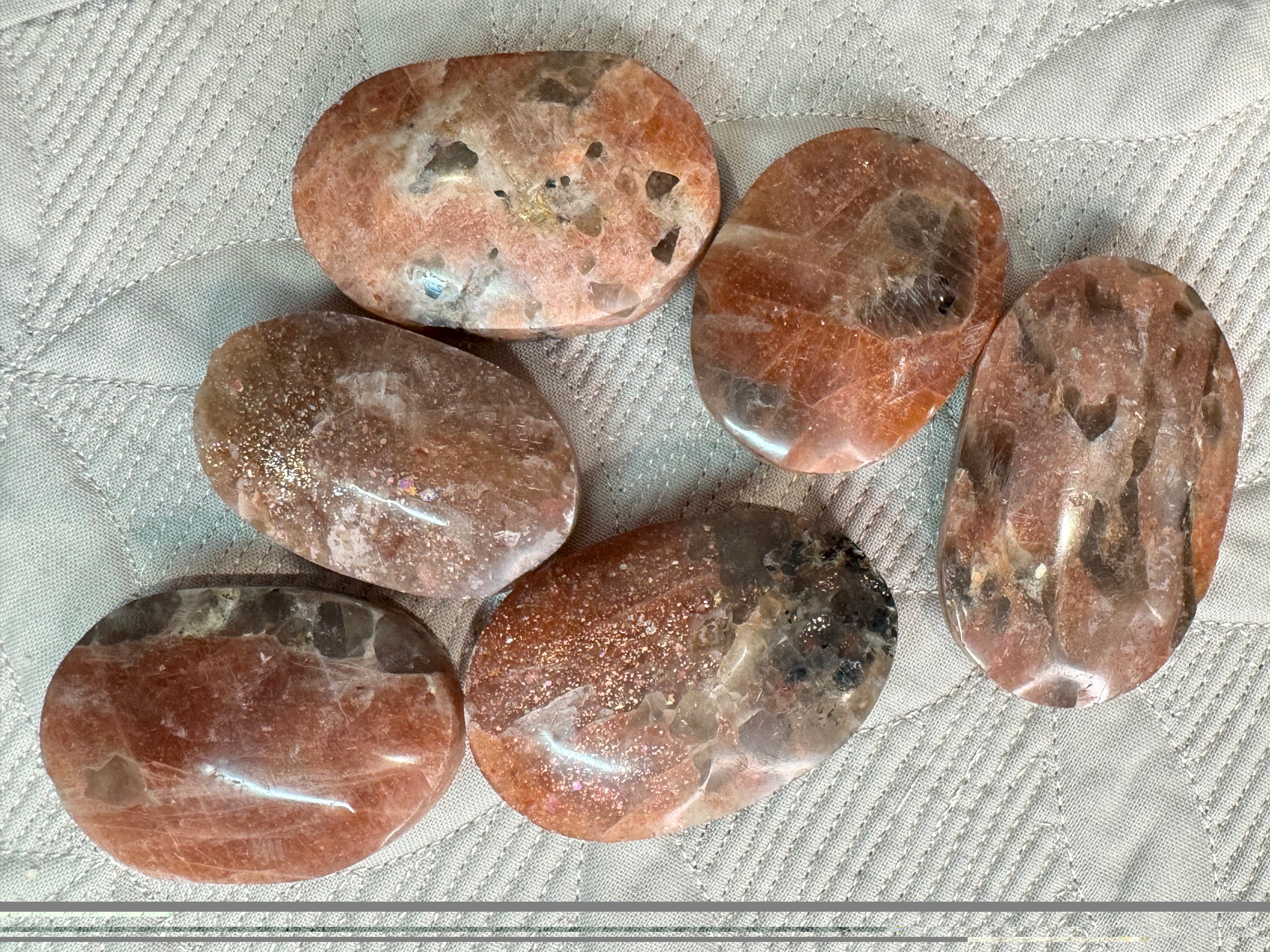 Set of polished brown stones on a textured white surface